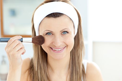 Woman with a makeup brush